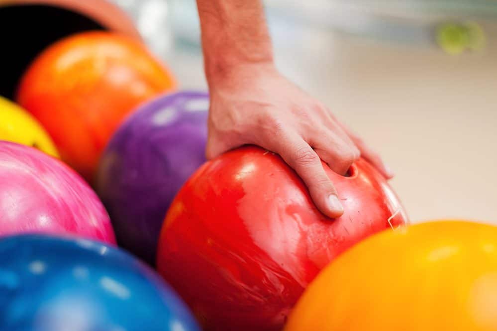 I choose this one. Close up of a hand holding bowling ball